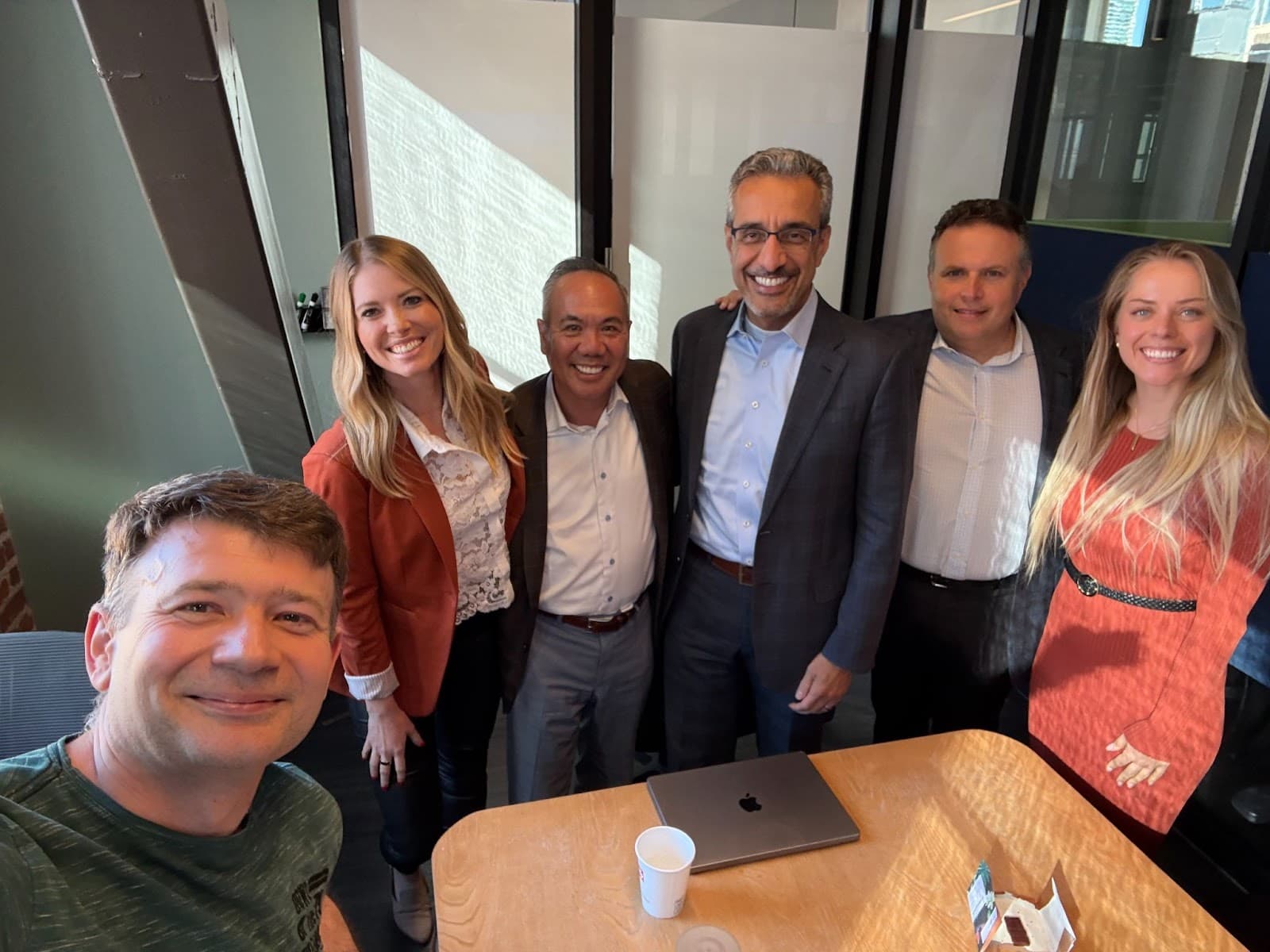 Dr. Michael Njo with healthcare and dental leaders in an office strategy setting.